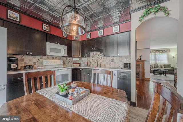 3305 Keswick Way Unit 3305D, West Chester, PA 19382 - kitchen with white appliances, an ornate ceiling, backsplash, light countertops, and dark brown cabinetry