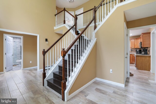 2299 Long Acre Dr, Effort, PA 18330 - stairway with wood finished floors, a high ceiling, and a baseboard radiator