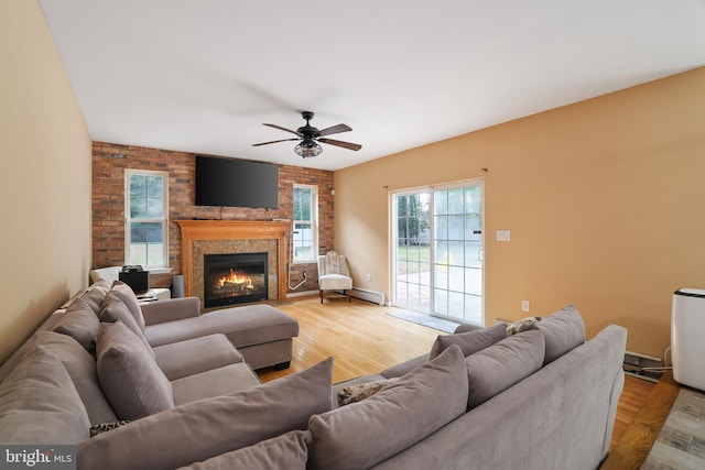 2299 Long Acre Dr, Effort, PA 18330 - living room with ceiling fan, baseboard heating, light wood-style flooring, and a brick fireplace