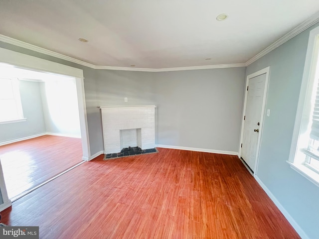 1609 S 28th St, Philadelphia, PA 19145 - unfurnished living room featuring wood finished floors, a brick fireplace, and ornamental molding