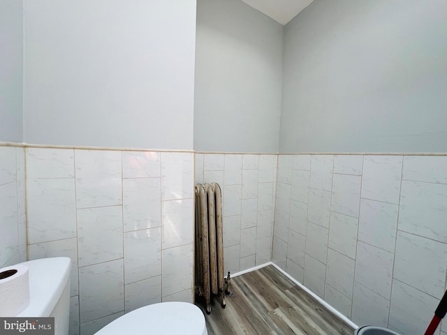 1609 S 28th St, Philadelphia, PA 19145 - bathroom with tile walls, wood finished floors, radiator, and a wainscoted wall