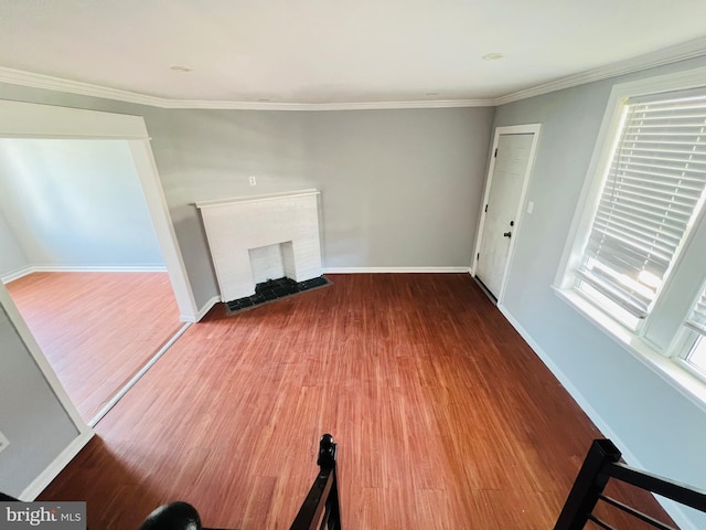 1609 S 28th St, Philadelphia, PA 19145 - unfurnished living room featuring wood finished floors, ornamental molding, and a fireplace