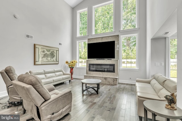 1631 E Strasburg Rd, West Chester, PA 19380 - living room featuring high vaulted ceiling, healthy amount of natural light, wood finished floors, and a fireplace
