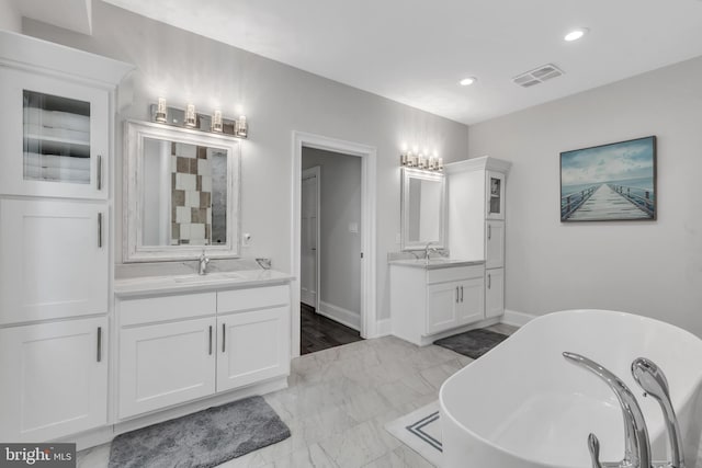 1631 E Strasburg Rd, West Chester, PA 19380 - full bath featuring a freestanding bath, two vanities, recessed lighting, and marble finish floors