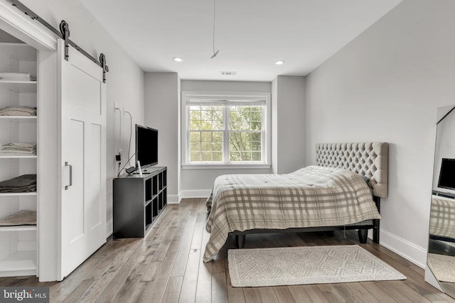 1631 E Strasburg Rd, West Chester, PA 19380 - bedroom featuring a barn door, light wood finished floors, and recessed lighting