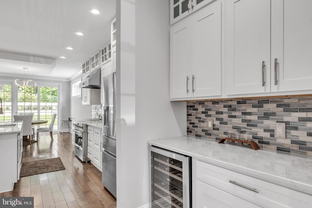 1631 E Strasburg Rd, West Chester, PA 19380 - kitchen featuring stainless steel appliances, wine cooler, white cabinets, recessed lighting, and wood finished floors