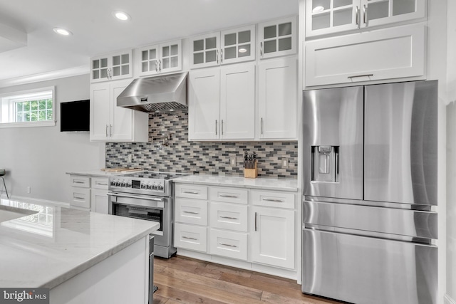 1631 E Strasburg Rd, West Chester, PA 19380 - kitchen featuring stainless steel appliances, under cabinet range hood, white cabinets, decorative backsplash, and recessed lighting