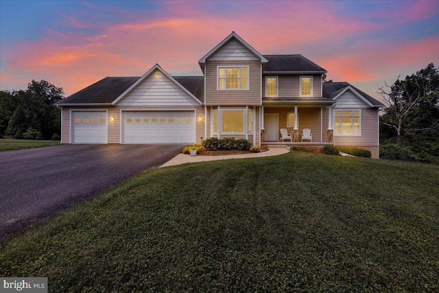 96 Gunhart Rd, Mohnton, PA 19540 - traditional-style house with asphalt driveway, a garage, a front lawn, and covered porch