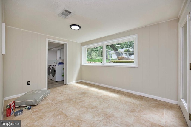 2301 N Tracy St, Alexandria, VA 22311 - tiled spare room featuring washer and dryer and baseboards