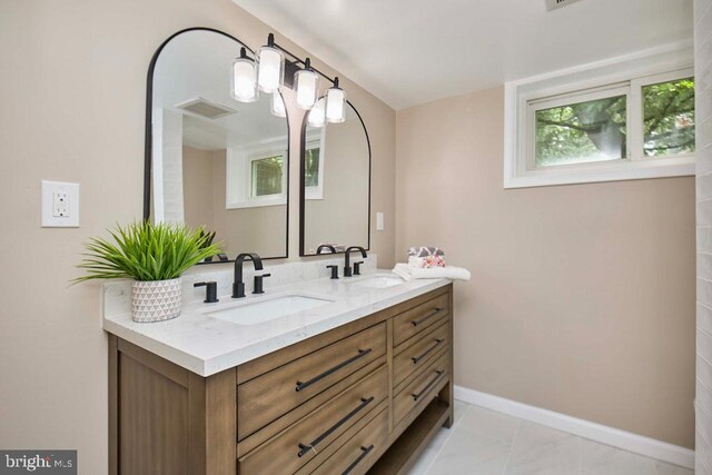2301 N Tracy St, Alexandria, VA 22311 - bathroom featuring double vanity and baseboards