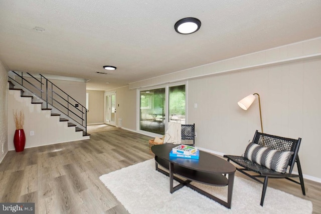 2301 N Tracy St, Alexandria, VA 22311 - sitting room featuring stairway, wood finished floors, and a textured ceiling