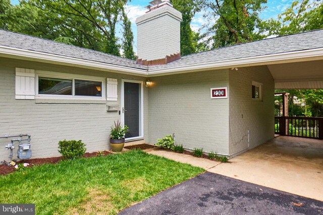 2301 N Tracy St, Alexandria, VA 22311 - entrance to property with brick siding, a chimney, roof with shingles, and driveway
