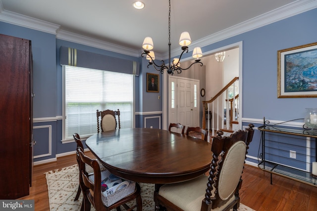 247 Torrey Pine Ct, West Chester, PA 19380 - dining room featuring crown molding, wood finished floors, a chandelier, a wainscoted wall, and stairway