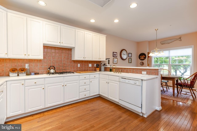 247 Torrey Pine Ct, West Chester, PA 19380 - kitchen featuring white appliances, a peninsula, light wood-type flooring, light countertops, and white cabinetry