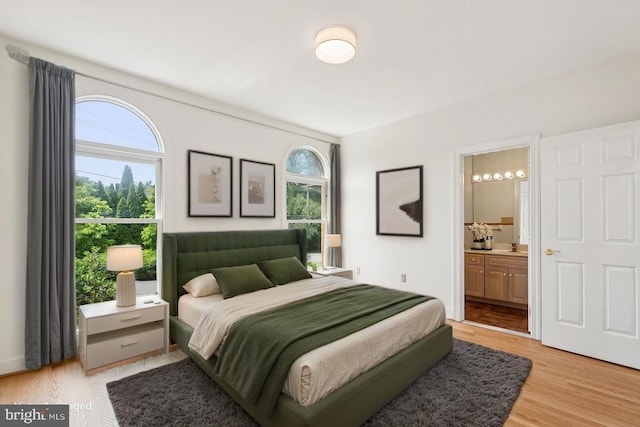 9309 Bells Mill Rd, Potomac, MD 20854 - bedroom with multiple windows, light wood-type flooring, and ensuite bathroom