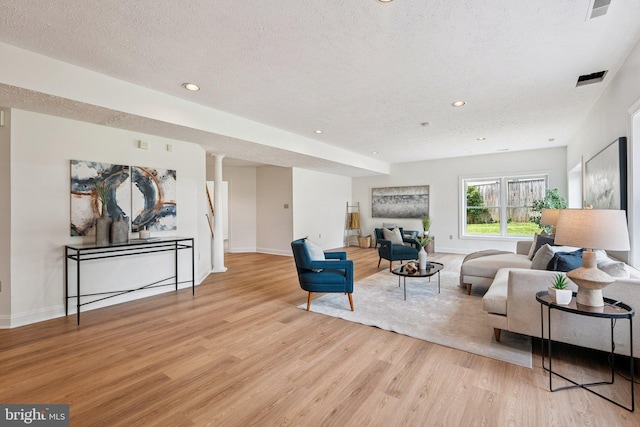 9309 Bells Mill Rd, Potomac, MD 20854 - living room with wood finished floors, a textured ceiling, and recessed lighting