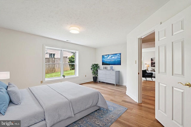 9309 Bells Mill Rd, Potomac, MD 20854 - bedroom with wood finished floors and a textured ceiling