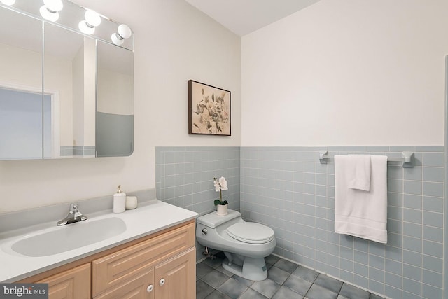 9309 Bells Mill Rd, Potomac, MD 20854 - bathroom with tile patterned floors, vanity, tile walls, and wainscoting