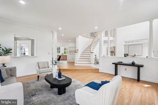 9309 Bells Mill Rd, Potomac, MD 20854 - living room featuring wood finished floors, decorative columns, stairs, and recessed lighting