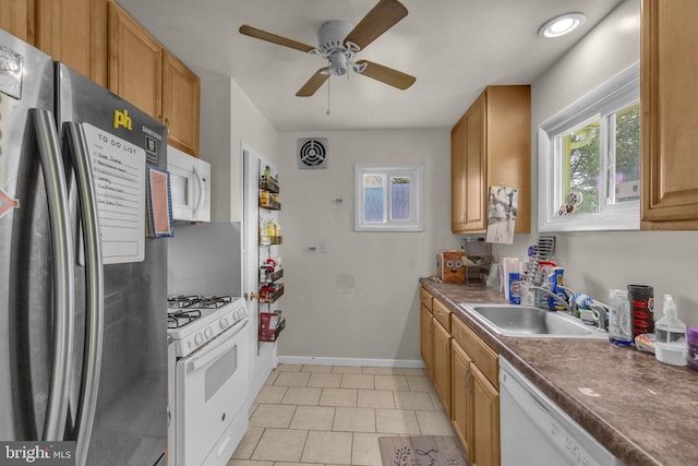 2306 Louise Ave, Baltimore, MD 21214 - kitchen with white appliances, ceiling fan, light tile patterned floors, and dark countertops