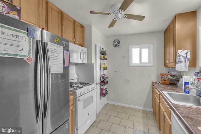 2306 Louise Ave, Baltimore, MD 21214 - kitchen featuring white appliances, a ceiling fan, light tile patterned floors, and brown cabinets
