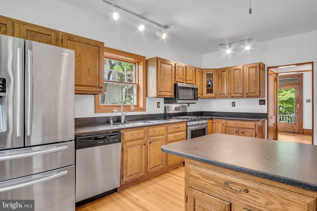 302 Bailey St, New Cumberland, PA 17070 - kitchen featuring stainless steel appliances, rail lighting, dark countertops, light wood-type flooring, and healthy amount of natural light
