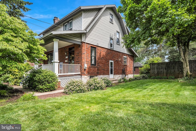 302 Bailey St, New Cumberland, PA 17070 - view of side of property featuring brick siding, covered porch, and a chimney
