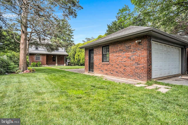 302 Bailey St, New Cumberland, PA 17070 - view of property exterior featuring brick siding, a lawn, and a garage