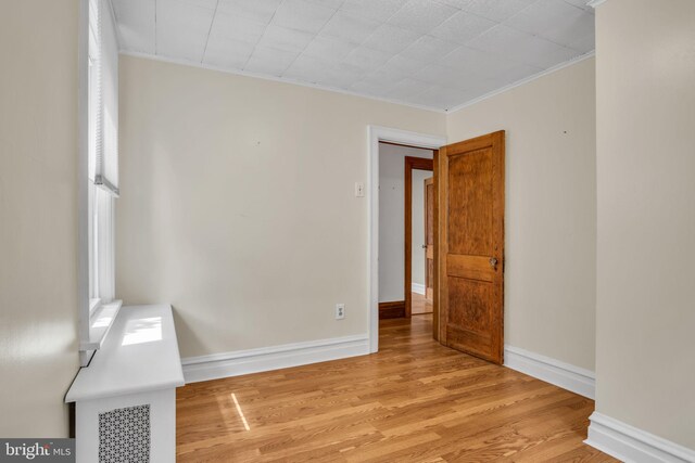 302 Bailey St, New Cumberland, PA 17070 - spare room featuring light wood-type flooring and ornamental molding