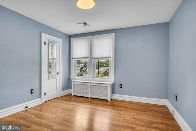 302 Bailey St, New Cumberland, PA 17070 - empty room with radiator and wood finished floors