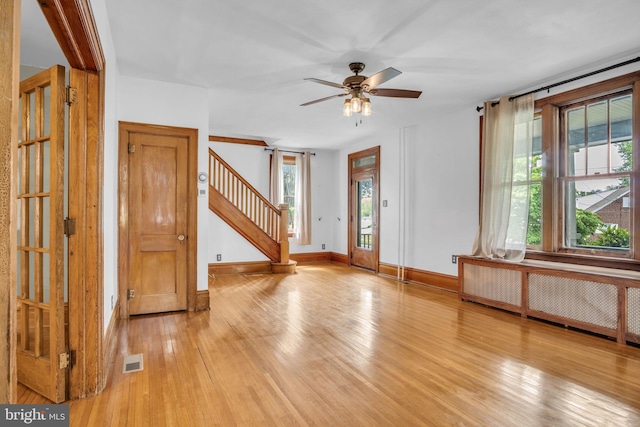 302 Bailey St, New Cumberland, PA 17070 - foyer featuring light wood-type flooring, stairs, radiator heating unit, and ceiling fan