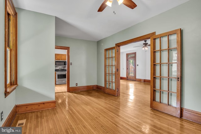 302 Bailey St, New Cumberland, PA 17070 - spare room featuring ceiling fan, french doors, and light wood-style floors