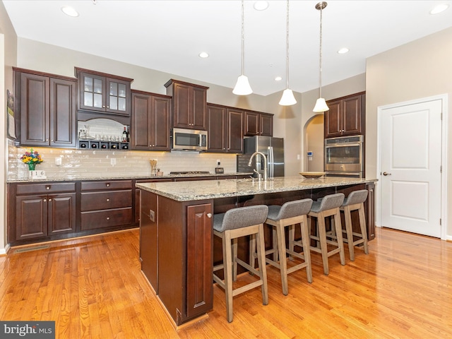 4714 De Invierno, Mount Airy, MD 21771 - kitchen with stainless steel appliances, light wood-style floors, dark brown cabinets, and recessed lighting