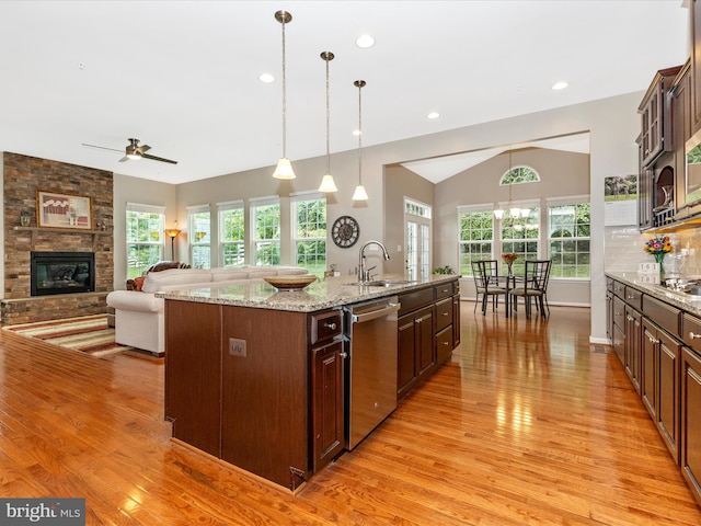 4714 De Invierno, Mount Airy, MD 21771 - kitchen featuring stainless steel appliances, light wood-style flooring, a stone fireplace, an island with sink, and recessed lighting