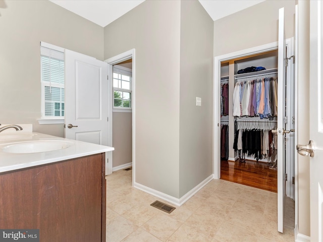4714 De Invierno, Mount Airy, MD 21771 - bathroom with double vanity, a spacious closet, and tile patterned floors