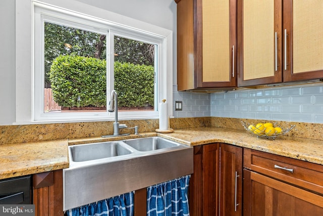 3010 26th St NE, Washington, DC 20018 - kitchen with decorative backsplash, light stone countertops, and brown cabinets