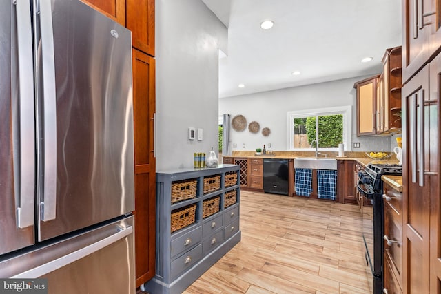 3010 26th St NE, Washington, DC 20018 - kitchen with black appliances, recessed lighting, light wood finished floors, light countertops, and beverage cooler