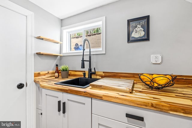 3010 26th St NE, Washington, DC 20018 - kitchen featuring wooden counters and white cabinets