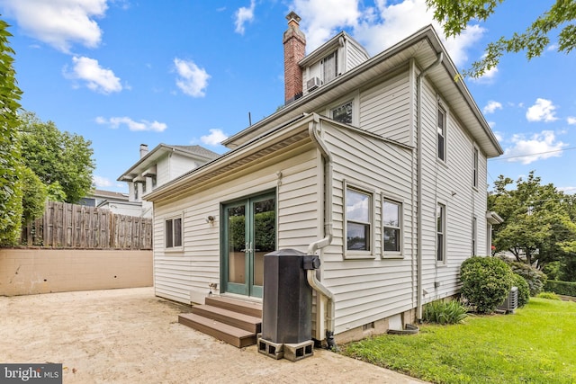 3010 26th St NE, Washington, DC 20018 - rear view of house featuring entry steps, a chimney, french doors, and a patio area