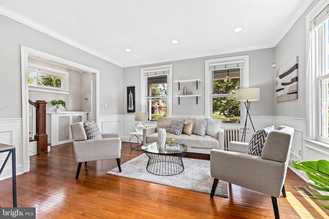 3010 26th St NE, Washington, DC 20018 - living room with healthy amount of natural light, a wainscoted wall, wood finished floors, a decorative wall, and ornamental molding