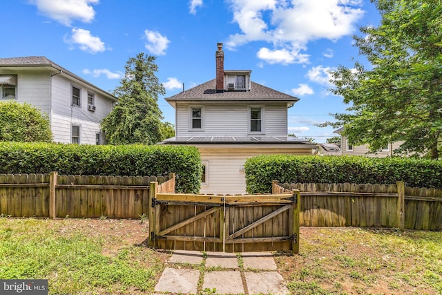 3010 26th St NE, Washington, DC 20018 - rear view of house featuring a chimney and a gate