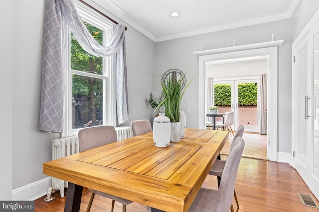 3010 26th St NE, Washington, DC 20018 - dining space with wood finished floors, ornamental molding, recessed lighting, and radiator