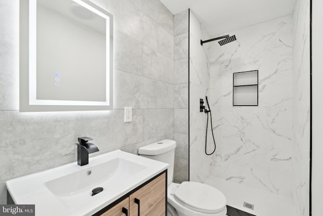 5937 Osage Ave Unit B, Philadelphia, PA 19143 - bathroom with toilet, vanity, a marble finish shower, and tile walls