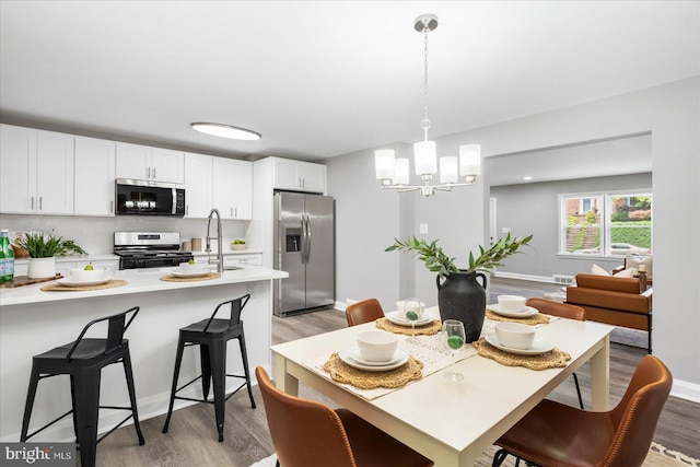 8119 Clyde Bank Rd, Towson, MD 21286 - dining space with light wood finished floors and a chandelier