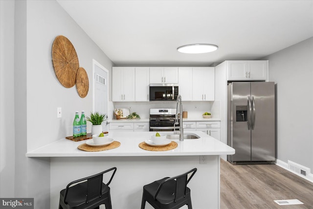 8119 Clyde Bank Rd, Towson, MD 21286 - kitchen with stainless steel appliances, a breakfast bar area, and light countertops