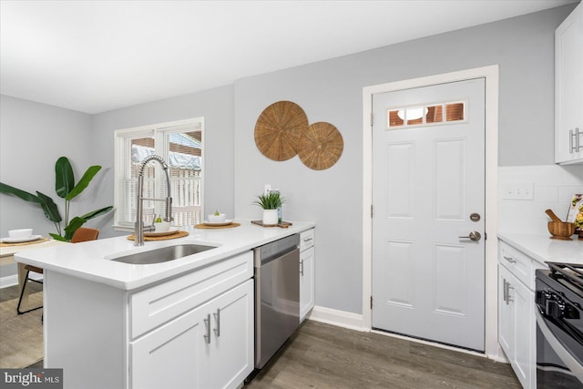 8119 Clyde Bank Rd, Towson, MD 21286 - kitchen with appliances with stainless steel finishes, a peninsula, dark wood-style flooring, and white cabinetry