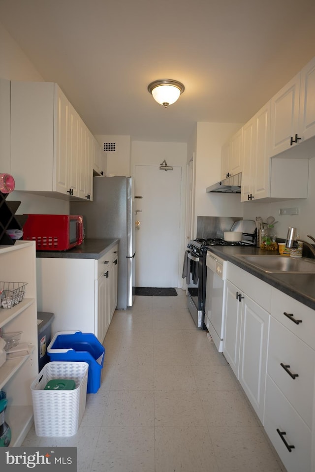 1900 Lyttonsville Rd Unit 514, Silver Spring, MD 20910 - kitchen with appliances with stainless steel finishes, a sink, light floors, white cabinets, and dark countertops