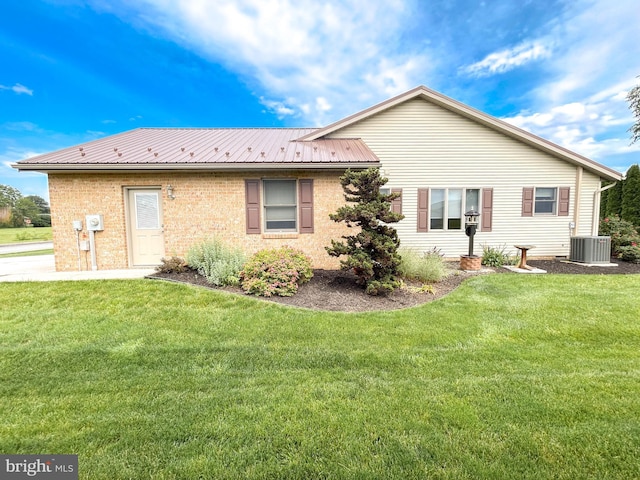 60 Parkwood Dr, Greencastle, PA 17225 - rear view of property featuring a yard, metal roof, cooling unit, and brick siding