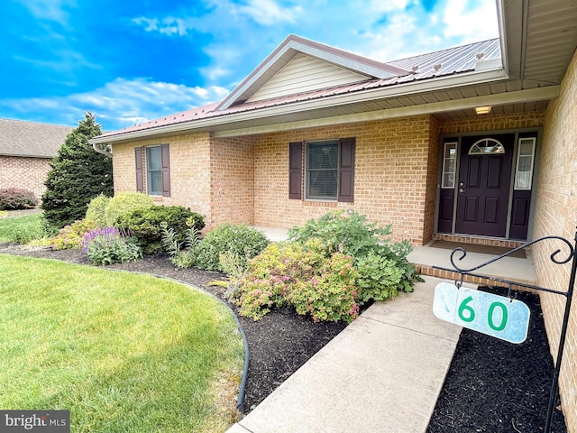60 Parkwood Dr, Greencastle, PA 17225 - doorway to property with brick siding, metal roof, and a yard