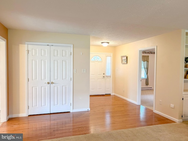 60 Parkwood Dr, Greencastle, PA 17225 - entrance foyer featuring baseboard heating, wood finished floors, and baseboards
